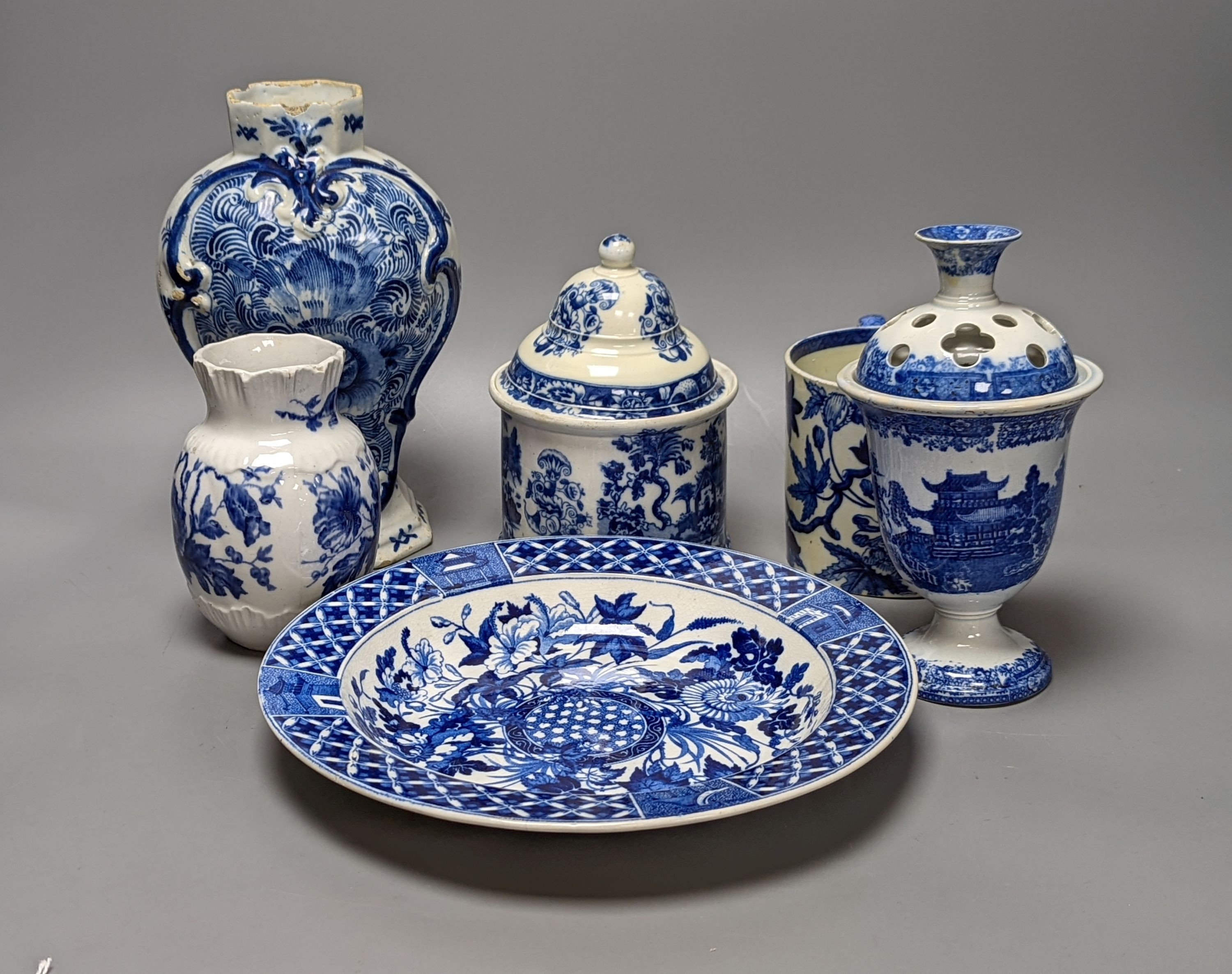 Four items of early 19th century blue and white pearlware pottery, an 18th century Delft blue and white vase and a 19th century toothbrush holder, Delft vase 22 cms high.